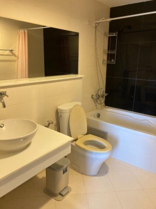 Modern bathroom with white fixtures and a bathtub