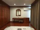 Spacious bedroom with built-in wooden wardrobes and desk