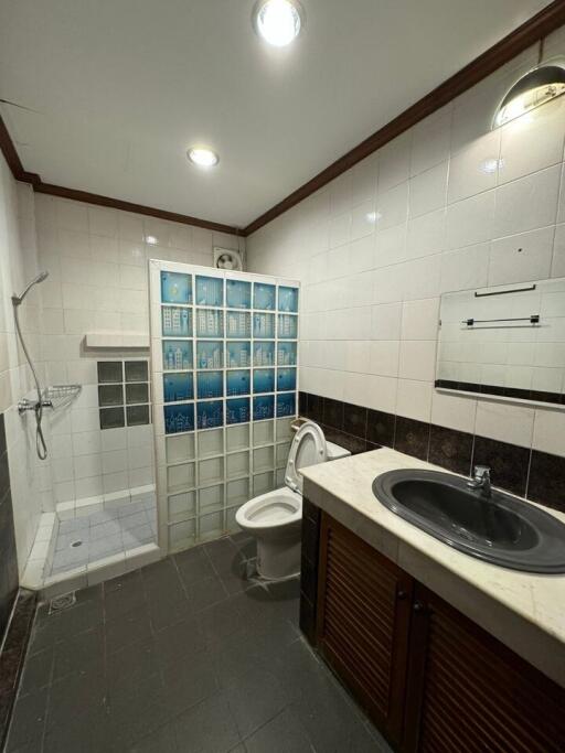 Modern bathroom with shower, toilet, and sink