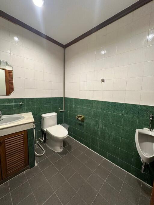 Spacious and clean bathroom with tiled walls and modern fixtures