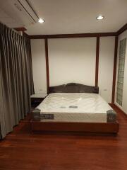 Bedroom with bed and hardwood floor