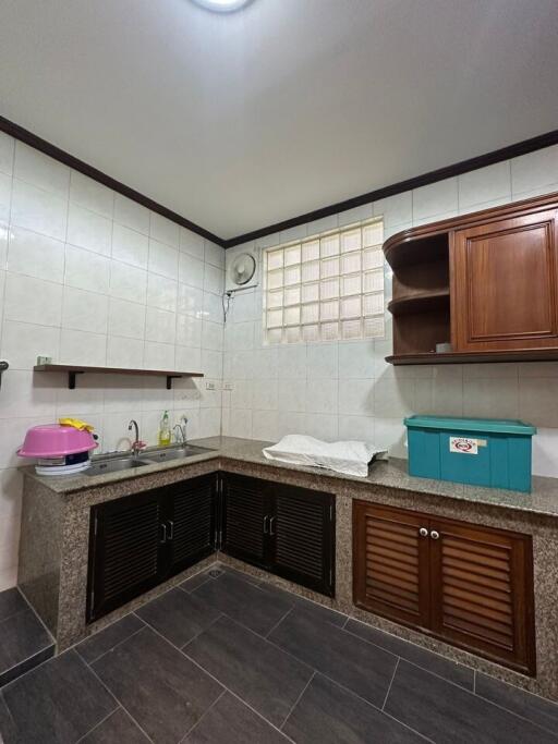 Modern kitchen with tiled floors and granite countertops