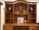 Elegant wooden entertainment center with decorative items