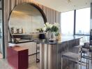 Modern kitchen with bar seating and city view