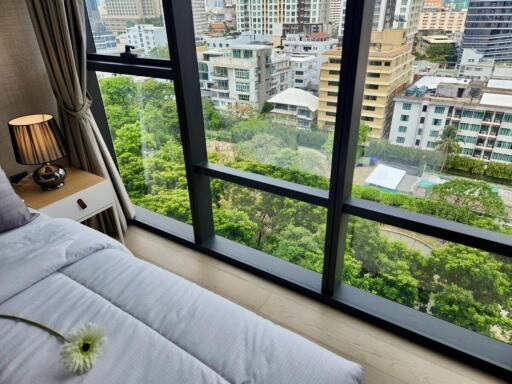 Bedroom with large windows and city view