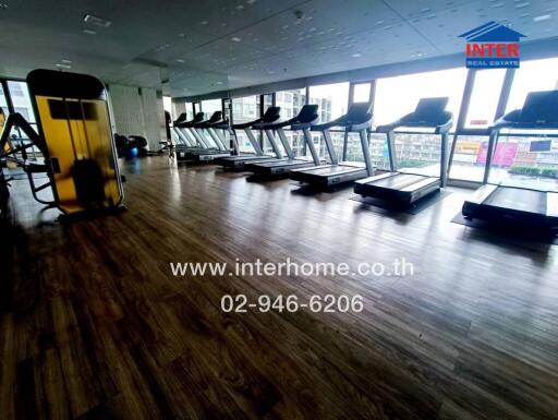 Modern fitness center with treadmills and large windows