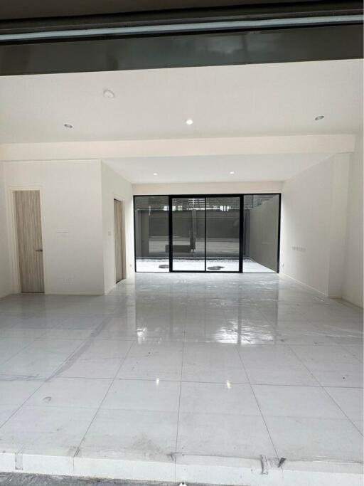 Spacious main living area with large windows and sliding glass doors