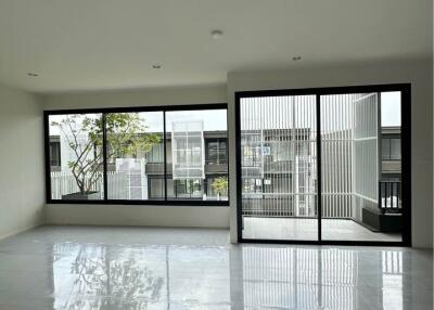 spacious living room with large windows and sliding glass door