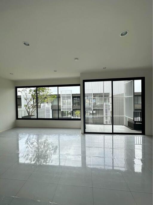 spacious living room with large windows and sliding glass door