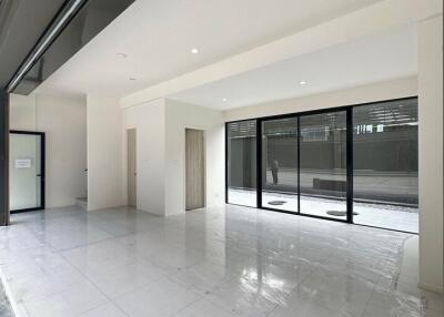 Spacious, modern living area with large windows and tiled floor