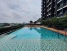 Outdoor swimming pool with view of building