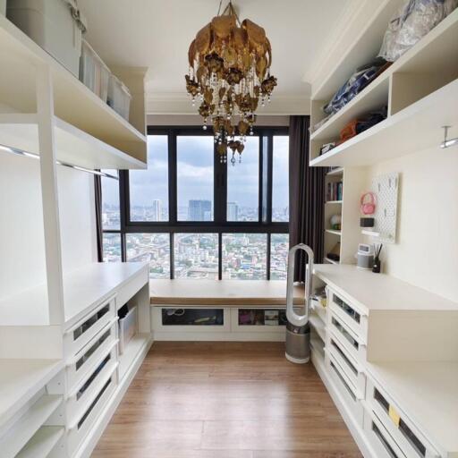 A well-organized home office with ample storage and a large window offering city views