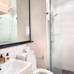 Modern bathroom with glass shower and white fixtures