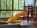 Indoor play area with slide and ball pit