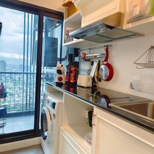 Modern kitchen with appliances and balcony view