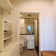 Modern bathroom with white fixtures, a sink, toilet, and a mirror