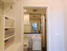 Modern bathroom with white fixtures, a sink, toilet, and a mirror