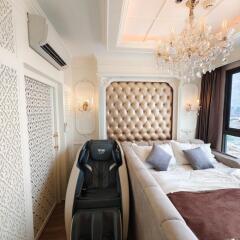 Luxurious bedroom with chandelier and massage chair