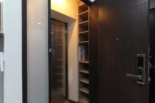 Elevator and entryway with shelving