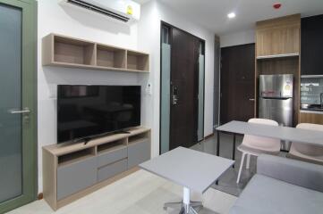 Modern living area with TV and kitchenette