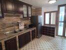 Modern kitchen with dark wooden cabinets and granite countertops