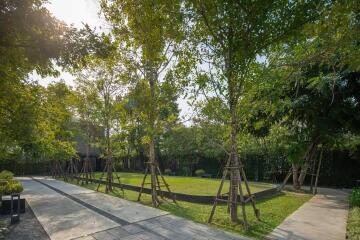 Spacious garden with trees and walking path