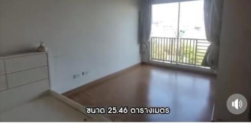 Unfurnished bedroom with large window and balcony access