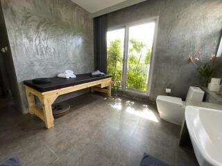 Modern bathroom with stone textures and large windows