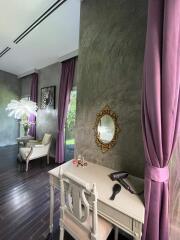 Elegant living area with makeup desk, mirror, and stylish decor