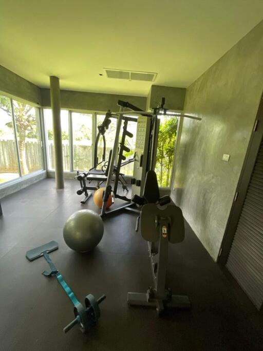 Well-equipped home gym with various exercise machines and equipment