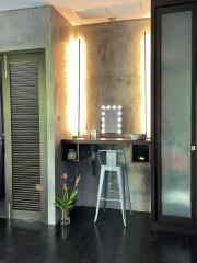 Modern bedroom vanity area with illuminated mirror