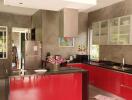 Modern kitchen with red cabinetry and stainless steel appliances