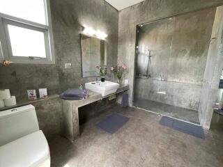 Modern bathroom with concrete-style walls and large shower