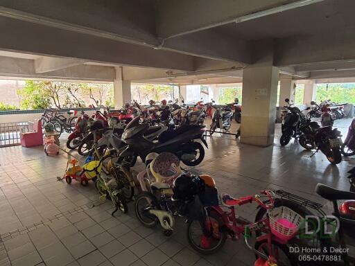 Indoor parking area with motorbikes and children