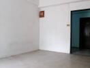 Empty room with door and white walls