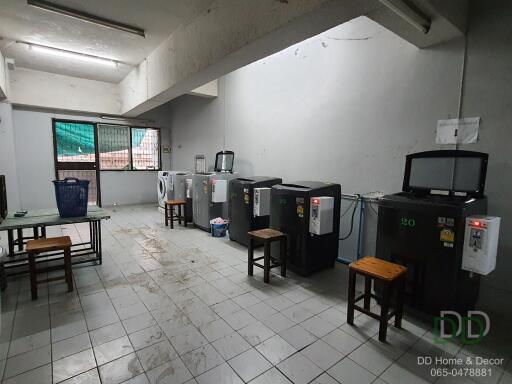 Laundry room with multiple washing machines and drying machines