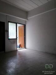 Empty room with open door and tiled floor