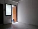 Empty room with open door and tiled floor