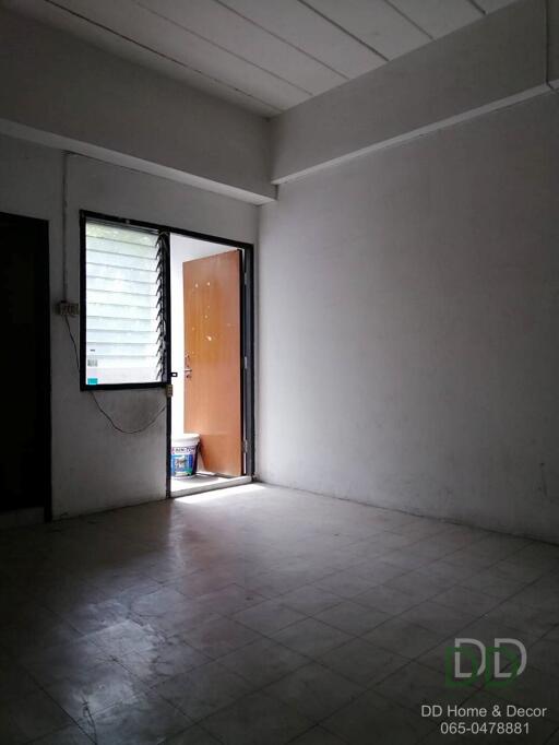 Empty room with open door and tiled floor