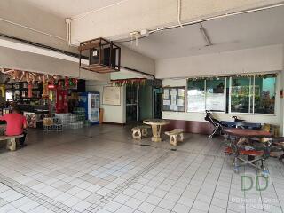 Communal area with tables, seating, and notice boards