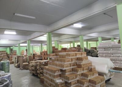 Large warehouse space with stacks of boxes and materials