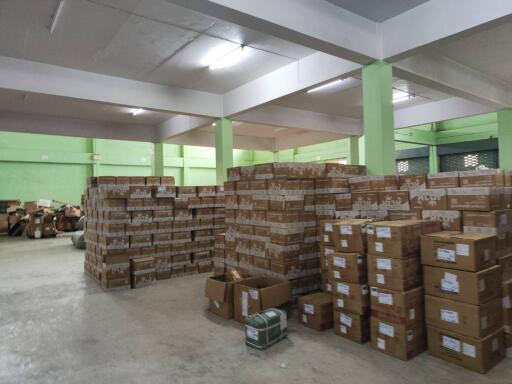 Spacious warehouse with multiple stacks of cardboard boxes