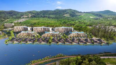 Aerial view of a large residential complex with surrounding greenery and a river