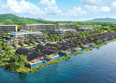 Aerial view of a waterfront resort property with multiple buildings and private villas