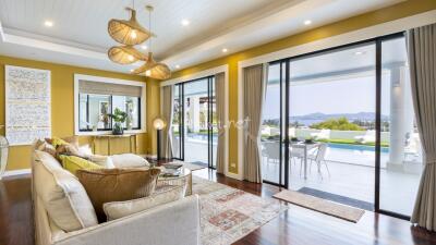 Spacious living room with large windows and pool view