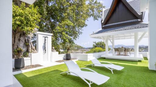 Beautiful outdoor area with lounge chairs and a covered dining space