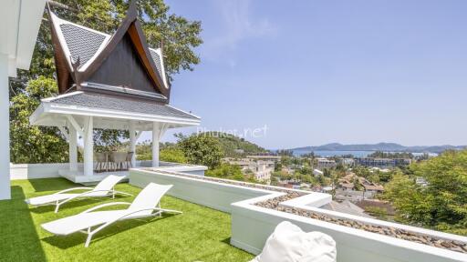 Outdoor terrace with lounge chairs and scenic view