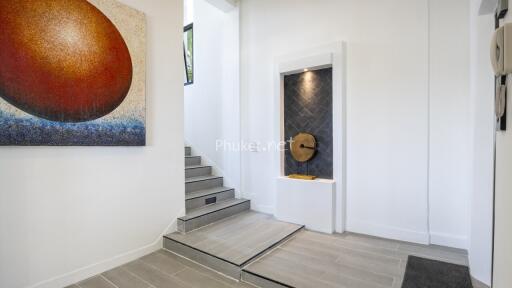 Modern entryway with stairs and artwork