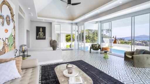 Modern living room with large windows overlooking a pool