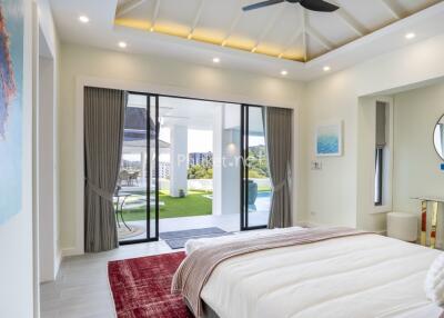 Modern bedroom with sliding glass doors opening to outdoor space